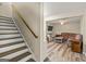 View of the staircase and a living room featuring a comfortable sofa and modern decor at 125 Tall Timber Ct, Fayetteville, GA 30215