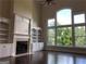 Inviting living room featuring a fireplace, built-in shelving and oversized windows at 2741 Willowstone Dr, Duluth, GA 30096