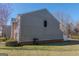 Side view of home showcasing siding, brick foundation, and green lawn at 1942 Grove Way, Hampton, GA 30228