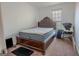 A cozy bedroom with a decorative headboard bed frame and neutral carpet at 1942 Grove Way, Hampton, GA 30228