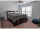 Spacious bedroom featuring a ceiling fan and a large window that lets in ample natural light at 1942 Grove Way, Hampton, GA 30228