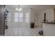 Open dining area filled with natural light, tiled flooring and a modern chandelier at 1942 Grove Way, Hampton, GA 30228