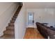 Bright foyer featuring hardwood floors, a staircase, and views into other rooms at 1942 Grove Way, Hampton, GA 30228