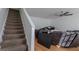 Carpeted stairs lead to the living area and a comfy sofa at 1942 Grove Way, Hampton, GA 30228