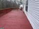 Large wooden back deck on a home, perfect for outdoor seating and relaxation, with white vinyl siding at 11 Carriage Lake Dr, Stockbridge, GA 30281