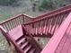 Stairs leading to the backyard; painted in red to match the style and tone of the deck at 11 Carriage Lake Dr, Stockbridge, GA 30281
