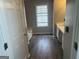 Bright bathroom featuring a bath and a vanity sink with wood-look flooring at 11 Carriage Lake Dr, Stockbridge, GA 30281
