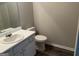 Neutral toned bathroom features a toilet, sink and mirror at 11 Carriage Lake Dr, Stockbridge, GA 30281