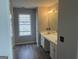Bathroom vanity with dual sinks, nice lighting, and wood-look flooring at 11 Carriage Lake Dr, Stockbridge, GA 30281