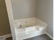 Clean white bathtub with chrome faucet, perfect for a relaxing soak at 11 Carriage Lake Dr, Stockbridge, GA 30281
