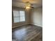 Bright bedroom with ceiling fan and window featuring wood-look flooring at 11 Carriage Lake Dr, Stockbridge, GA 30281