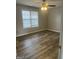 Bedroom featuring wood-look flooring, bright window and ceiling fan at 11 Carriage Lake Dr, Stockbridge, GA 30281