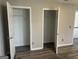 Bright bedroom features wood-look flooring and two closets for storage at 11 Carriage Lake Dr, Stockbridge, GA 30281