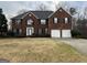 Charming two-story brick home with a two-car garage and traditional architectural details at 11 Carriage Lake Dr, Stockbridge, GA 30281