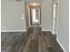 Hallway features neutral gray walls and durable wood-look flooring, leading into the home at 11 Carriage Lake Dr, Stockbridge, GA 30281