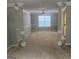 Spacious living room featuring decorative columns, neutral carpet, and ample natural light at 11 Carriage Lake Dr, Stockbridge, GA 30281