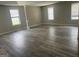 Bright living room with light gray walls, multiple windows, and durable wood-look flooring at 11 Carriage Lake Dr, Stockbridge, GA 30281