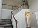 Elegant staircase featuring wood rails, painted banisters, and stylish, neutral decor at 11 Carriage Lake Dr, Stockbridge, GA 30281