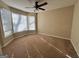 Bright bedroom featuring bay window, fan, and neutral walls at 1635 Kimble Sw Dr, Marietta, GA 30064