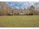 View of a charming single story home with stone accents and large front lawn at 106 Deadwood Way, Palmetto, GA 30268