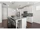 Modern kitchen featuring a large center island with bar seating, stainless steel appliances, and white cabinetry at 1977 Boyd Trace Nw Ln, Atlanta, GA 30318