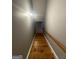 A wooden staircase leading downwards with a white-painted wall and rail at 2066 Tidwell Trl, Stone Mountain, GA 30088