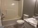 This bathroom includes a toilet, sink, vanity, mirror, tub, and shower at 1694 Social Circle Fairplay Rd, Social Circle, GA 30025