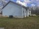 Exterior view of a light blue home with a deck and a well-kept lawn at 1694 Social Circle Fairplay Rd, Social Circle, GA 30025