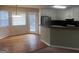 Bright kitchen with white cabinets, black countertops, black appliances, and hardwood-floored dining area at 1694 Social Circle Fairplay Rd, Social Circle, GA 30025