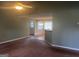 Cozy living room featuring brown carpet, ceiling fan, and an opening to another room at 1694 Social Circle Fairplay Rd, Social Circle, GA 30025