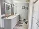 Stylish bathroom with dual vanities, framed mirrors, and modern lighting fixtures at 3213 Sweetbriar Dr, Villa Rica, GA 30180
