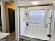 Modern bathroom with a glass-enclosed shower featuring white marble-patterned walls and contemporary fixtures at 3213 Sweetbriar Dr, Villa Rica, GA 30180