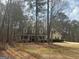 Inviting home with dormers and a welcoming front porch surrounded by mature trees at 3213 Sweetbriar Dr, Villa Rica, GA 30180