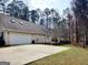 Two-car garage with a spacious driveway and a cozy backyard at 3213 Sweetbriar Dr, Villa Rica, GA 30180