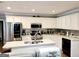 Bright kitchen featuring stainless steel appliances, white cabinets, and stylish backsplash at 3213 Sweetbriar Dr, Villa Rica, GA 30180