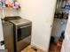 Laundry room with washer, dryer, and storage shelves at 3213 Sweetbriar Dr, Villa Rica, GA 30180