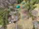 Aerial view of the cabin with a green metal roof, its utility building, and the wooded surroundings at 1266 Martin Mill Rd, Moreland, GA 30259