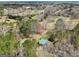 Aerial view of cabin and surroundings, showcasing the expansive land and proximity to other homes at 1266 Martin Mill Rd, Moreland, GA 30259