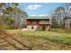 Exterior of home with deck and wooded view at 1266 Martin Mill Rd, Moreland, GA 30259