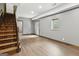 Finished basement featuring wood-look floors, neutral walls, and a staircase at 1266 Martin Mill Rd, Moreland, GA 30259