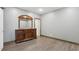 Finished basement showcasing wood-look floors and a wooden dresser with mirror at 1266 Martin Mill Rd, Moreland, GA 30259