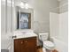 Bathroom featuring wood sink vanity, toilet, towel rack, and shower-tub combo at 1266 Martin Mill Rd, Moreland, GA 30259