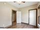 Bedroom featuring hardwood flooring, ceiling fan, base trim and two doors at 1266 Martin Mill Rd, Moreland, GA 30259