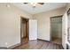 Bedroom featuring hardwood flooring, ceiling fan, base trim and two doors at 1266 Martin Mill Rd, Moreland, GA 30259