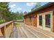 Wide wooden deck accessible from double doors, perfect for enjoying the surrounding wooded scenery at 1266 Martin Mill Rd, Moreland, GA 30259