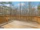 Spacious wooden deck with railings, perfect for outdoor relaxation and entertaining with a view of the trees at 1266 Martin Mill Rd, Moreland, GA 30259