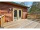 Close-up of the wooden deck featuring double doors, great for enjoying nature from the comfort of your home at 1266 Martin Mill Rd, Moreland, GA 30259