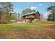 Exterior of the two-story house with a green roof and a wooden deck at 1266 Martin Mill Rd, Moreland, GA 30259