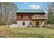 Exterior of a two-story home with green roof and wood siding plus back deck at 1266 Martin Mill Rd, Moreland, GA 30259
