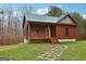 Charming log cabin featuring a quaint front porch and a stone pathway leading to the entrance at 1266 Martin Mill Rd, Moreland, GA 30259